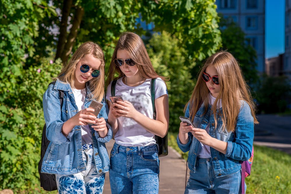 Gefahren in den Sozialen Netzwerken erkennen und vermeiden shutterstock_1126166891 Jugendliche mit Smartphones